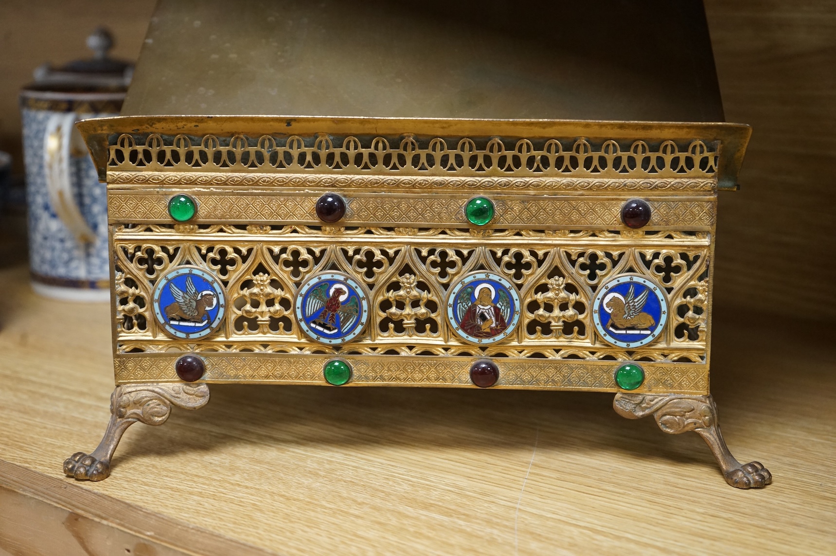 A French Limoges enamel and gilt metal lectern stand with glass cabochons and paw feet, 30cm wide